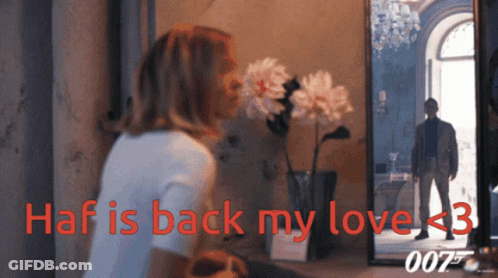 A Woman Looks At Her Reflection In A Mirror With The Words Haf Is Back My Love < 3 GIF