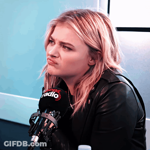 A Woman Making A Face Behind A Microphone That Says Fox Radio GIF