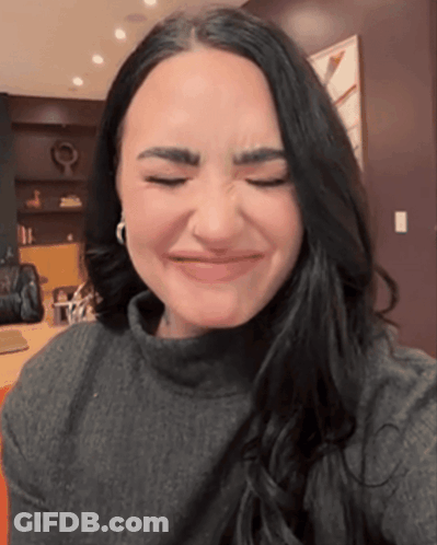 A Woman Making A Face With Her Eyes Closed GIF