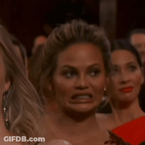 A Woman Making A Funny Face In A Crowd GIF