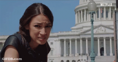 A Woman Making A Funny Face In Front Of A Building With Netflix Written On The Bottom GIF