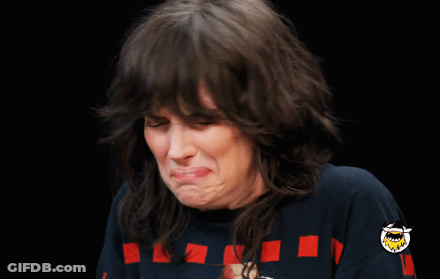 A Woman Making A Funny Face Wearing A Blue Shirt GIF