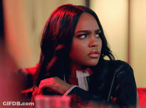 A Woman Making A Funny Face With Her Arms Crossed GIF