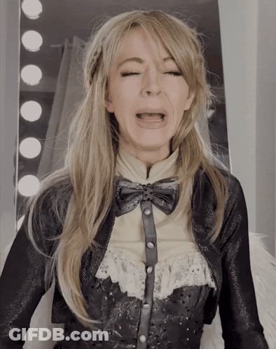 A Woman Making A Funny Face With Her Eyes Closed And Her Mouth Open GIF