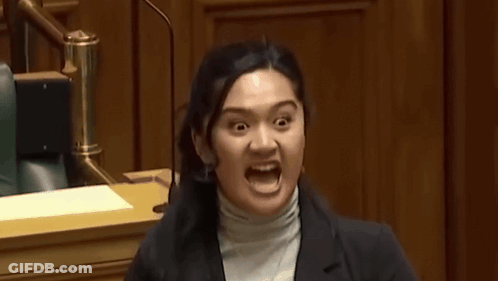 A Woman Making A Funny Face With Her Mouth Wide Open GIF