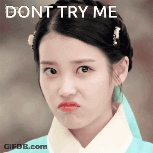 A Woman Making A Funny Face With The Words " Dont Try Me " Behind Her GIF
