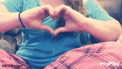 A Woman Making A Heart Shape With Her Hands GIF