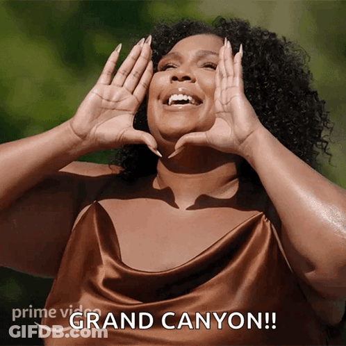 A Woman Making A Heart With Her Hands And The Words Grand Canyon On The Bottom Right GIF