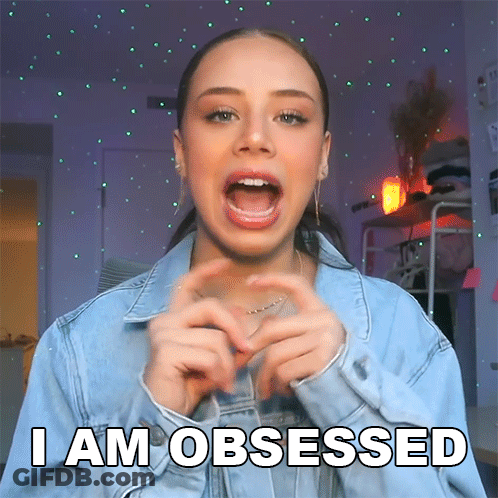 A Woman Making A Heart With Her Hands And The Words I Am Obsessed Above Her GIF