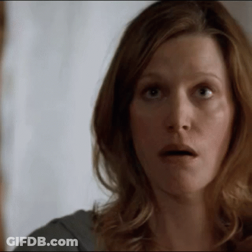 A Woman Making A Surprised Face With Her Mouth Open GIF