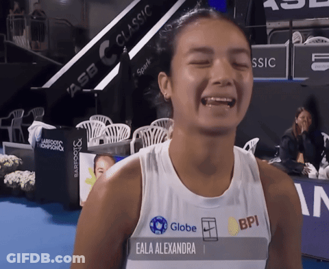 A Woman Named Eala Alexandra Wears A White Tank Top With Globe And Bpi Logos On It GIF
