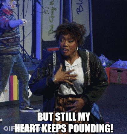 A Woman On Stage With The Words But Still My Heart Keeps Pounding On The Bottom GIF