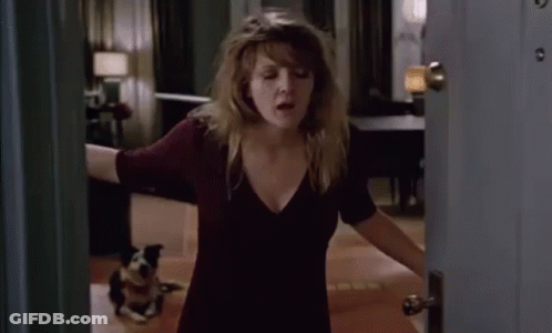 A Woman Opens A Door To A Room With A Dog On The Floor GIF