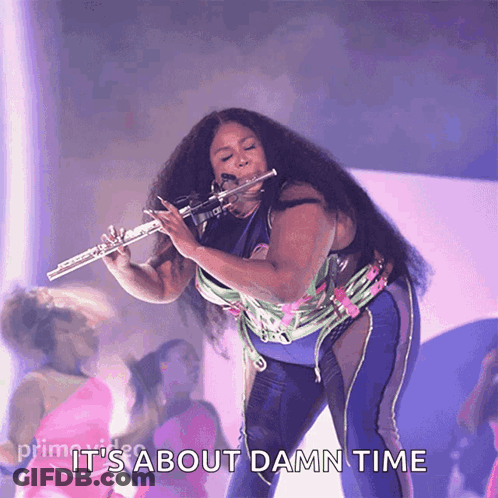 A Woman Playing A Flute With The Words " It 'S About Damn Time " Below Her GIF