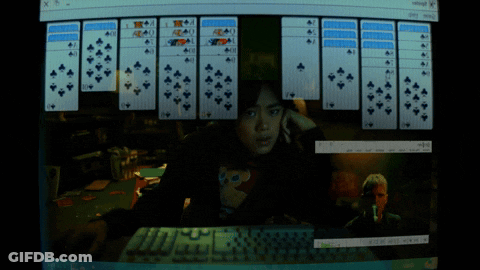 A Woman Playing A Game Of Solitaire On A Computer GIF