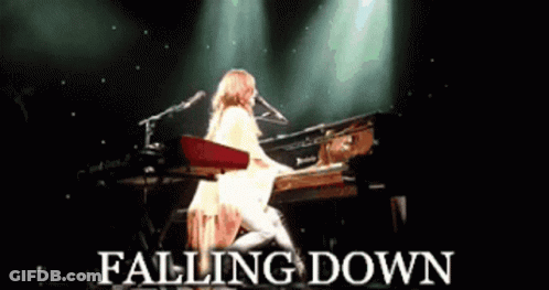 A Woman Playing A Piano With The Words Falling Down Written Below Her GIF