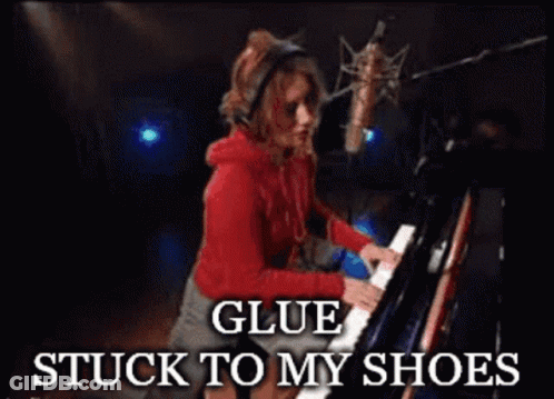 A Woman Playing A Piano With The Words Glue Stuck To My Shoes Below Her GIF