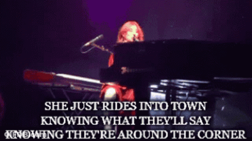 A Woman Playing A Piano With The Words She Just Rides Into Town Above Her GIF
