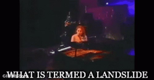 A Woman Playing A Piano With The Words " What Is Termed A Landslide " Written Below Her GIF