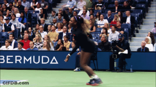 A Woman Playing Tennis In Front Of A Banner For Bermuda GIF