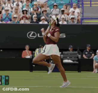 A Woman Playing Tennis In Front Of A Lexus Sign GIF