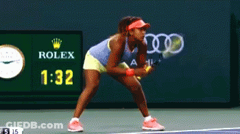 A Woman Playing Tennis In Front Of A Rolex Ad GIF