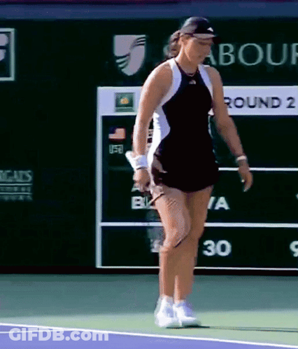 A Woman Playing Tennis In Front Of A Scoreboard That Says " Round 2 " GIF