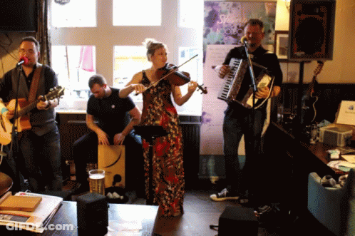 A Woman Plays A Violin While Two Men Play Guitars GIF