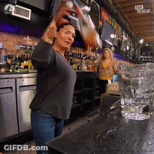 A Woman Pouring A Drink In A Bar With A Sign That Says Bar Rescue GIF