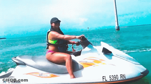 A Woman Riding A Yamaha Jet Ski In The Ocean GIF