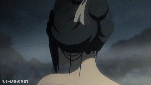 A Woman 'S Back Is Shown With A Bun And A Feather In Her Hair GIF