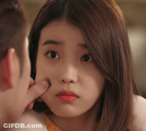 A Woman 'S Face Is Being Touched By A Man 'S Finger GIF