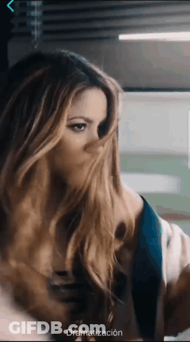 A Woman 'S Face Is Covered By Her Hair And The Word Dramatización Is On The Bottom GIF