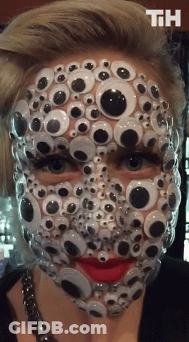 A Woman 'S Face Is Covered In Googly Eyes With The Letters Th On The Bottom GIF