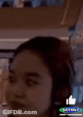 A Woman 'S Face Is Shown With A Skynet Logo In The Background GIF