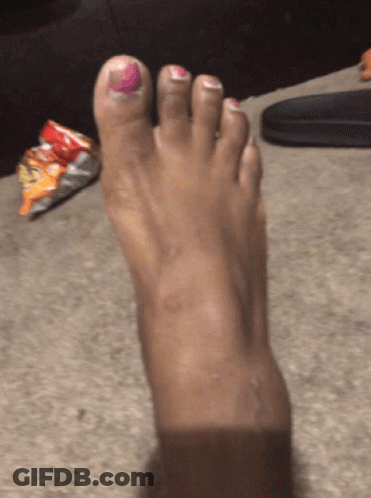 A Woman 'S Foot With Pink Nail Polish On The Toe GIF