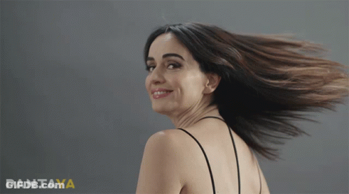 A Woman 'S Hair Is Blowing In The Wind In Front Of A Pantaya Ad GIF