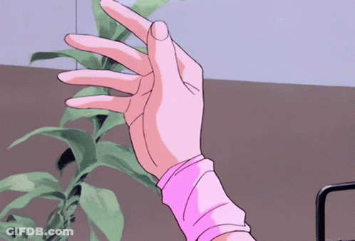 A Woman 'S Hand In A Pink Sweater Is Reaching Out Towards A Plant GIF