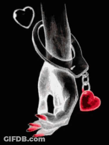 A Woman 'S Hand In Handcuffs Holding A Heart GIF