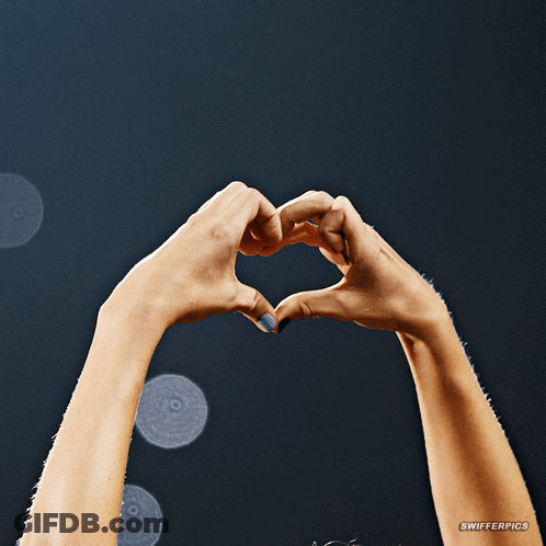 A Woman 'S Hands Are Making A Heart Shape With A Watermark That Says Swiferpics GIF