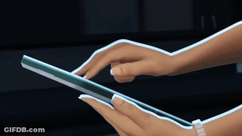 A Woman 'S Hands Are Shown Using A Tablet GIF