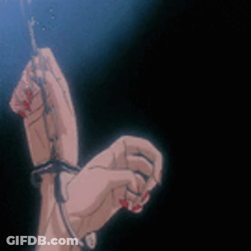 A Woman 'S Hands Are Tied To A Chain In A Dark Room . GIF