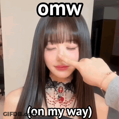 A Woman 'S Nose Is Being Touched By A Person With The Words Omw On My Way Above Her GIF