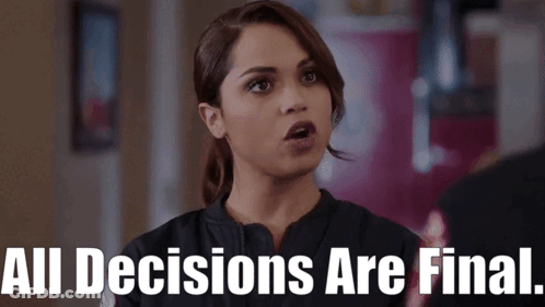 A Woman Says " All Decisions Are Final " In Front Of A Red Wall GIF