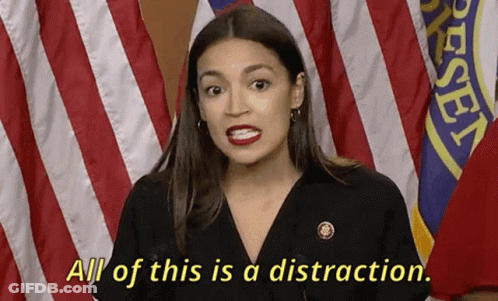 A Woman Says All Of This Is A Distraction While Standing In Front Of American Flags GIF
