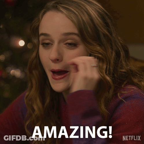A Woman Says Amazing In Front Of A Netflix Sign GIF