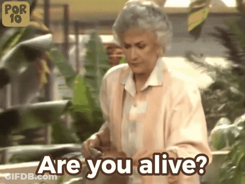 A Woman Says " Are You Alive " In Front Of Plants GIF