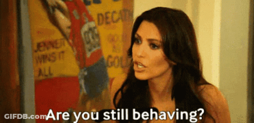 A Woman Says " Are You Still Behaving " In Front Of A Poster That Says Jenner Wins It All GIF