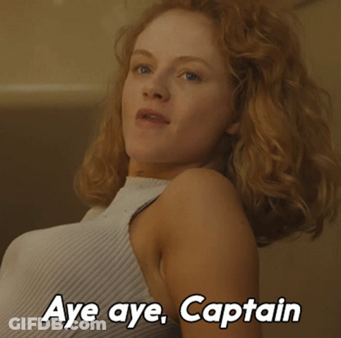 A Woman Says Aye Aye Captain In A White Shirt GIF