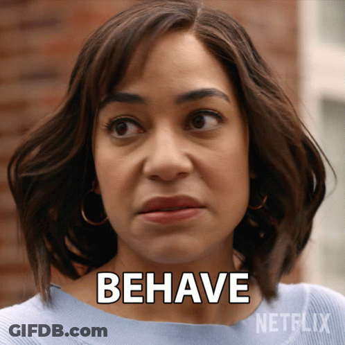 A Woman Says " Behave " In Front Of A Netflix Advertisement GIF
